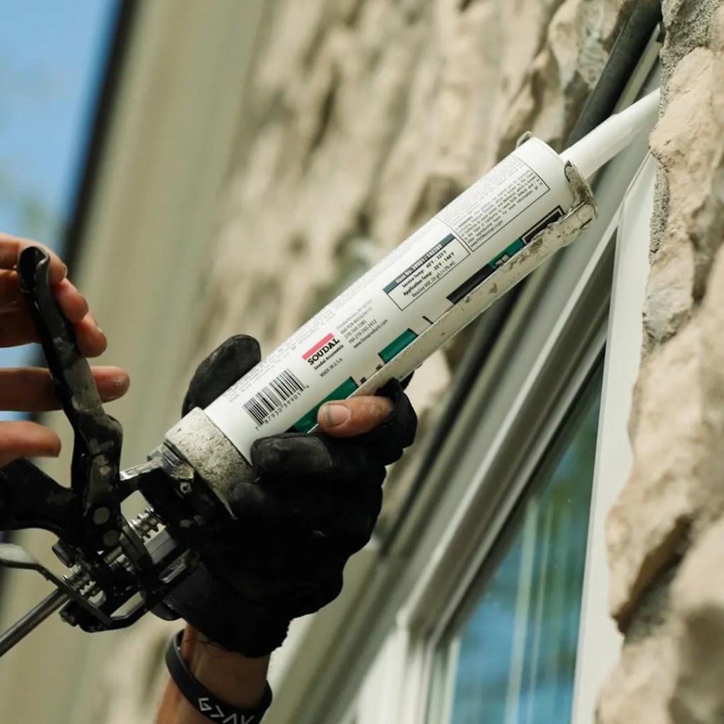 Window Installer applying sealants